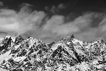 Image showing Black and white snowy rocks at sunny day