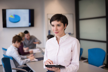 Image showing hispanic businesswoman with tablet at meeting room