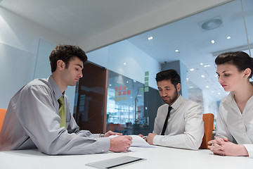 Image showing young couple signing contract documents on partners back