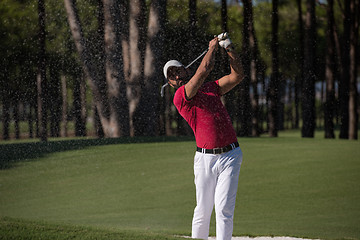 Image showing golfer hitting a sand bunker shot