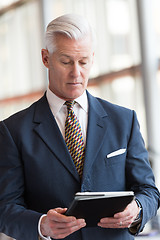 Image showing senior business man working on tablet computer