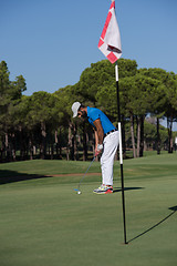 Image showing golf player hitting shot at sunny day