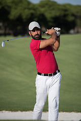 Image showing golfer hitting a sand bunker shot