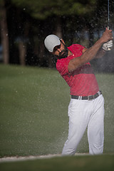 Image showing golfer hitting a sand bunker shot