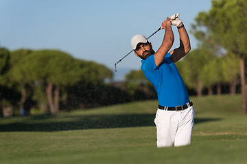Image showing pro golfer hitting a sand bunker shot