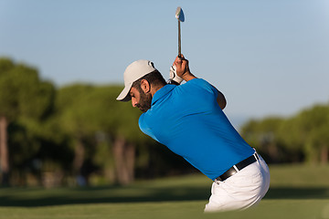 Image showing pro golfer hitting a sand bunker shot