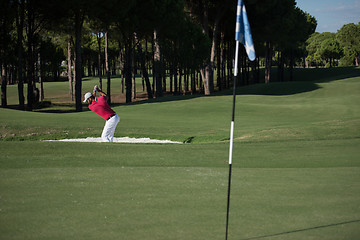 Image showing golfer hitting a sand bunker shot