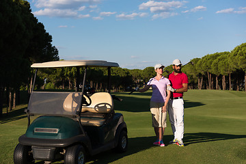 Image showing couple in buggy on golf course