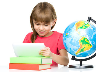 Image showing Young girl is using tablet