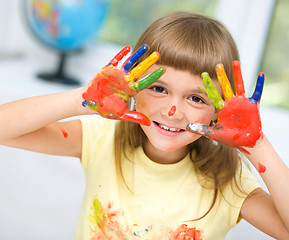 Image showing Portrait of a cute girl playing with paints