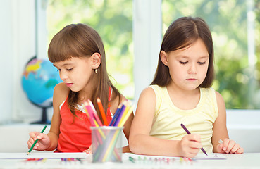 Image showing Little girls are drawing using pencils