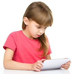 Image showing Young girl is using tablet