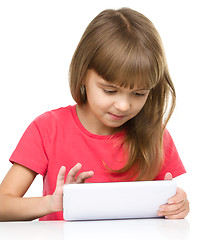 Image showing Young girl is using tablet