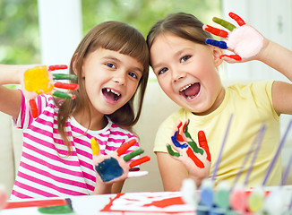 Image showing Little girls are painting with gouache