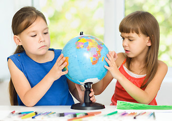 Image showing Little girls are examining globe