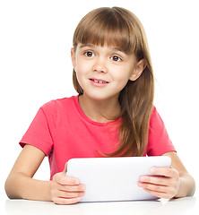 Image showing Young girl is using tablet