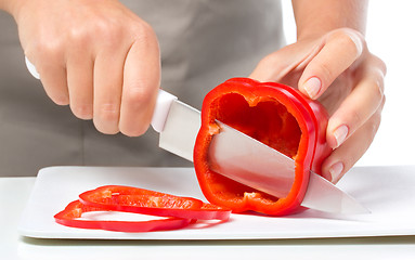 Image showing Cook is chopping bell pepper