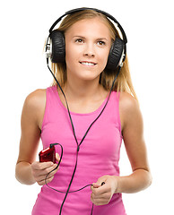 Image showing Teen girl enjoying music using headphones