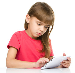 Image showing Young girl is using tablet