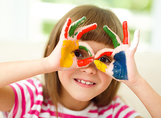 Image showing Portrait of a cute girl playing with paints