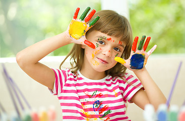 Image showing Portrait of a cute girl playing with paints