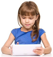 Image showing Young girl is using tablet while studying