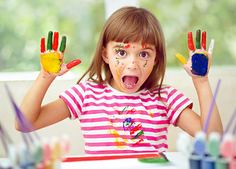 Image showing Portrait of a cute girl playing with paints