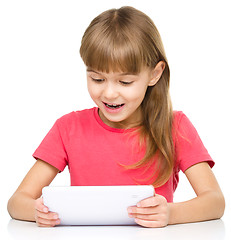Image showing Young girl is using tablet
