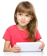 Image showing Young cheerful girl is using tablet