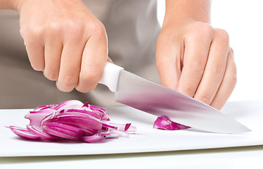 Image showing Cook is chopping onion