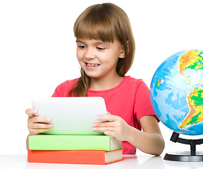 Image showing Young girl is using tablet