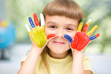 Image showing Portrait of a cute girl playing with paints