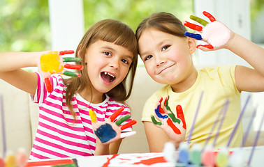 Image showing Little girls are painting with gouache