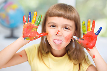 Image showing Portrait of a cute girl playing with paints