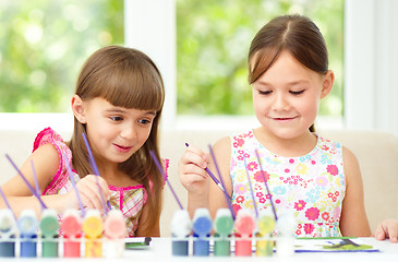 Image showing Little girls are painting with gouache