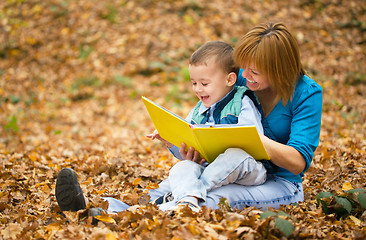 Image showing Mother is reading book with her son