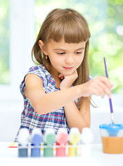 Image showing Little girl is painting with gouache