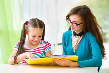 Image showing Mother is reading book with her daughter