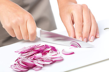 Image showing Cook is chopping onion