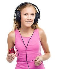 Image showing Teen girl enjoying music using headphones