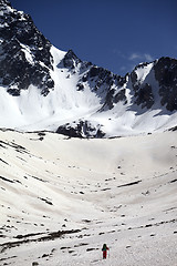 Image showing Hiker in snowy mountains at nice spring day