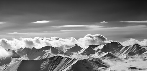 Image showing Black and white panoramic view on cloudy mountains in evening