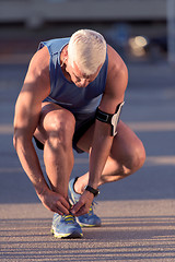 Image showing Man tying running shoes laces