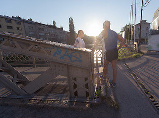 Image showing jogging couple planning running route  and setting music