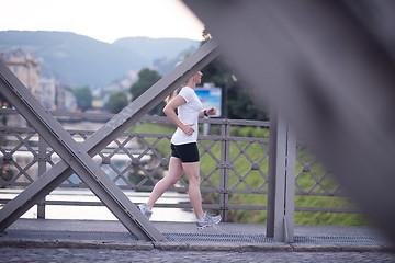 Image showing sporty woman running  on sidewalk