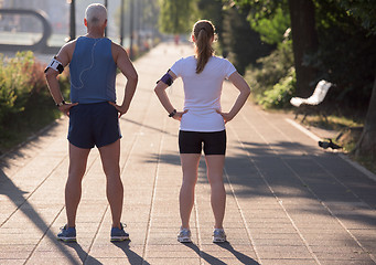 Image showing jogging couple planning running route  and setting music