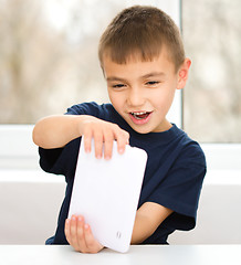 Image showing Young boy is using tablet