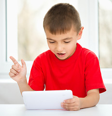 Image showing Young boy is using tablet