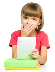 Image showing Young girl is using tablet while studying