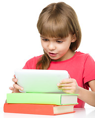 Image showing Young girl is using tablet